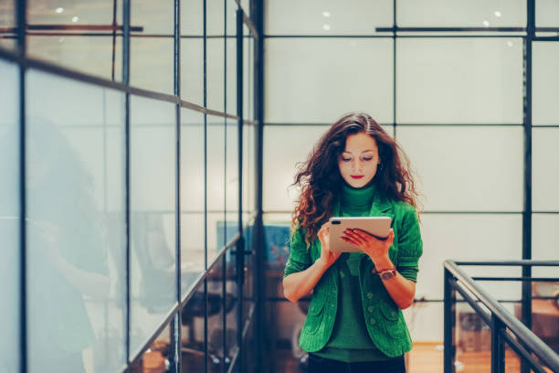 istock Businesswoman using digital tablet in the office 1411995477