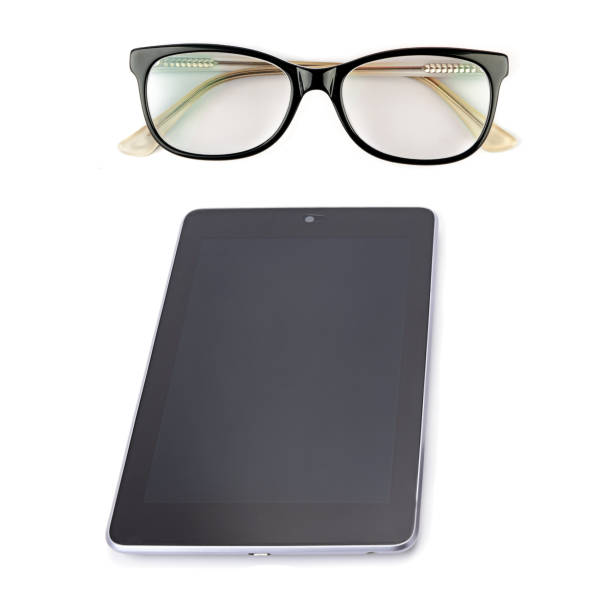 istock Tablet and glasses isolated on white 1411996941