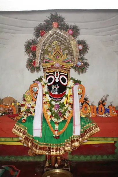 Photo of Deities to be worshipped. Closeup of a Colorful statue of Lord Jagannath deity. Indian religious icon