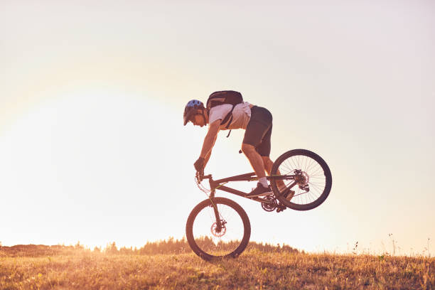istock A cyclist riding a bike on a mountain at sunset 1412002385