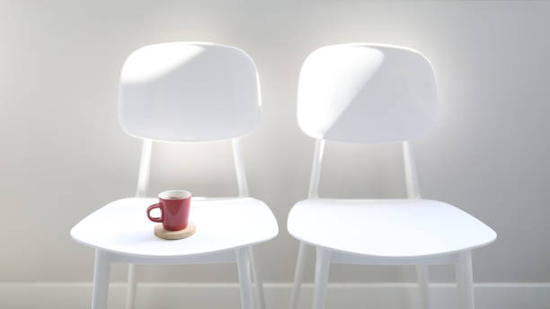 A bible and pair of coffee cups on a table in a glowing kitchenOther images from this series: