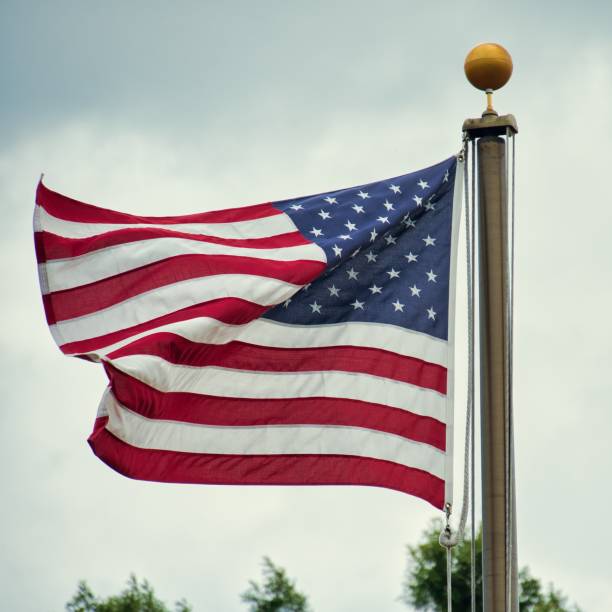 istock American Flag Blowing in Wind 1412002927
