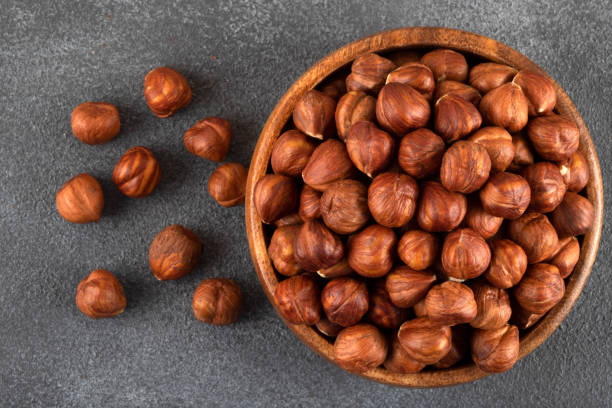 istock Bowl full of hazelnuts  on dark background 1412003646