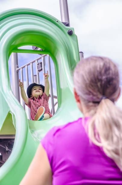 istock Toddler boy getting ready to slide down 1412004044