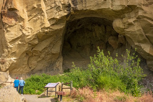 Billings, MT, USA - June 23, 2022: Tourists explore Pictograph Cave, a State Park, home to three caves containing 2000 year old Native American paintings.