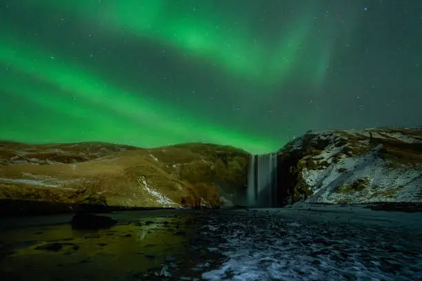 Northern lights over Skogafoss, great waterfall in the south of iceland