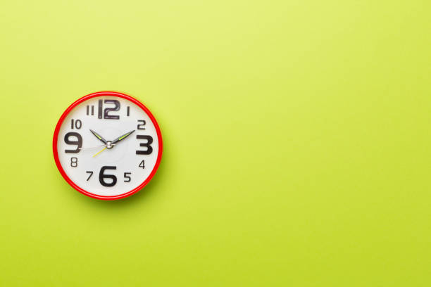 istock Red alarm clock on color background, top view 1412008192