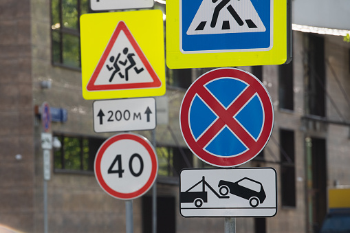 Multiple bright road signs: high-altitude, children ahead, 40 speed limit and others