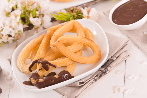 istock Churros with chocolate dipping sauce. 1412011025