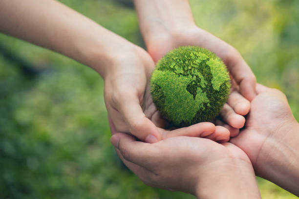 environment earth day in the hands holding green earth on bokeh green background, saving environment, and environmentally sustainable. save earth. concept of the environment world earth day - milieubehoud stockfoto's en -beelden
