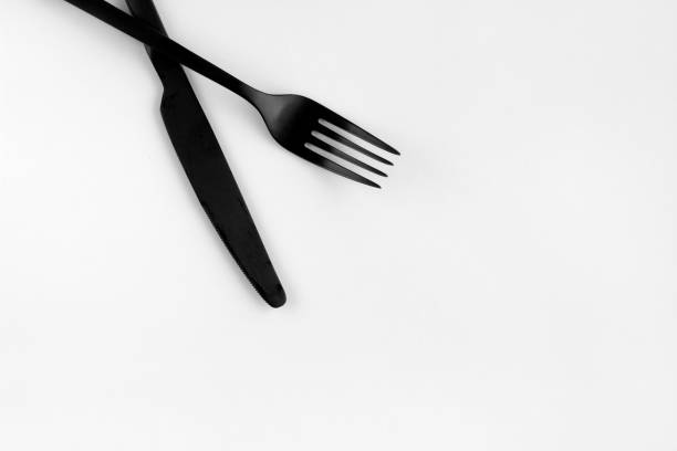 istock Black fork and knife isolated on white background 1412017301