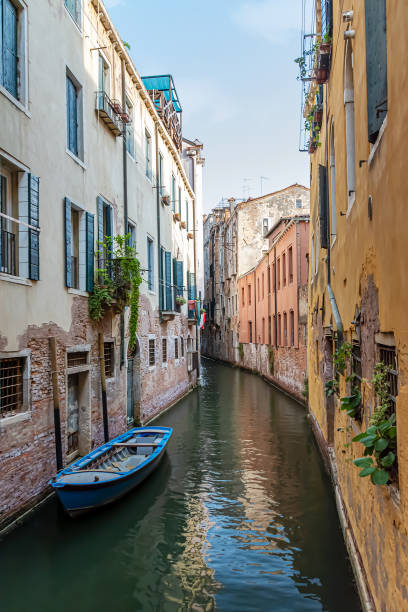 Narrow canal with old colorful houses in Venice, Italy stock photo