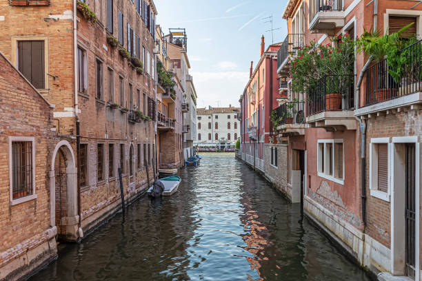 Narrow canal with old colorful houses in Venice, Italy stock photo
