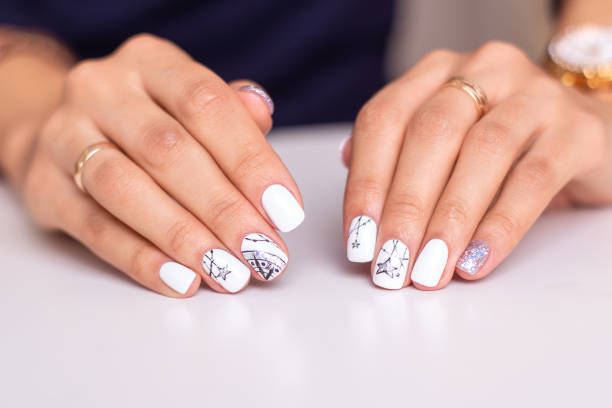 istock Female hands with silver colored manicure nails 1412021134