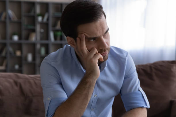 istock Close up thoughtful man looking in distance, lost in thoughts 1412021249