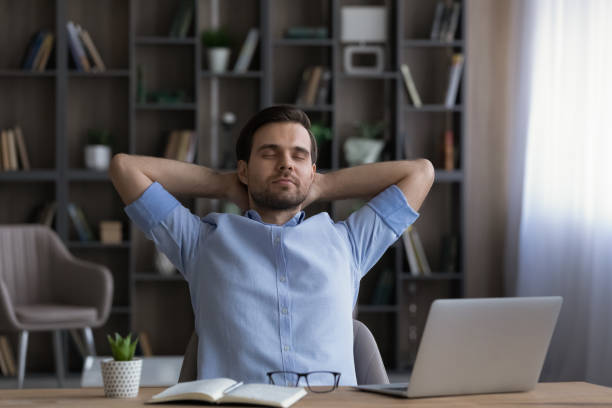 istock Calm businessman leaning back in office chair during break 1412021493