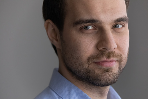 Head shot portrait confident 30s bearded man looking at camera on grey background, serious handsome millennial guy posing for profile picture, successful businessman entrepreneur looking at camera