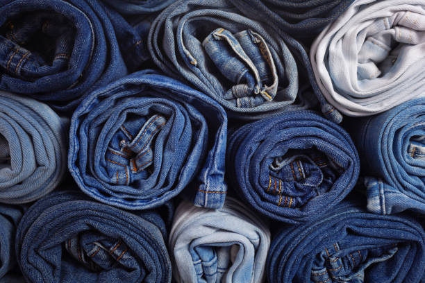 istock Blue jeans denim heap background. Jeans fabric heap as material surface 1412023613