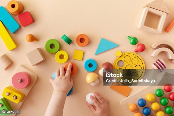 Toddler Activity For Motor And Sensory Development Baby Hands With Colorful Wooden Toys On Table From Above Stock Photo - Download Image Now