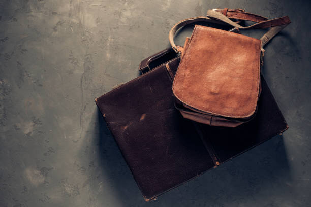 istock Old suitcase and bag on floor background texture. Travel concept idea 1412027485