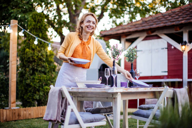 istock Woman serving outdoor party table 1412028574