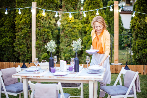 istock Woman serving outdoor party table 1412028584