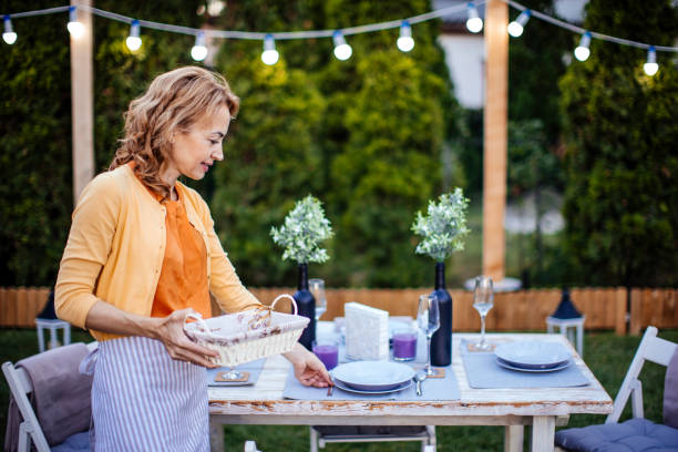 istock Woman serving outdoor party table 1412028629