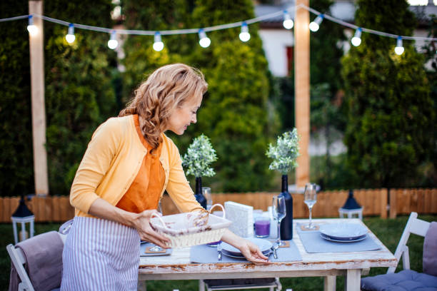 istock Woman serving outdoor party table 1412028636