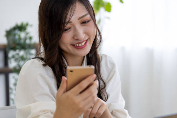istock A Japanese woman checking smartphone by remote work in the small office 1412029138