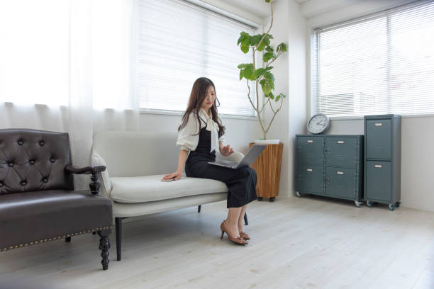 istock A Japanese woman checking smartphone by remote work in the small office 1412029575