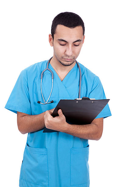 istock young doctor writing in clipboard 141203041
