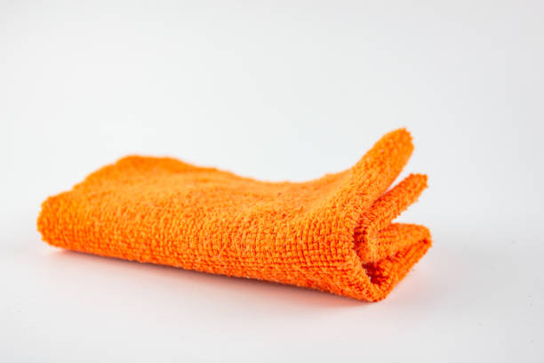 istock Fiber cloth for cleaning. Rag for cleaning dust.Orange rag on a white background. 1412030743