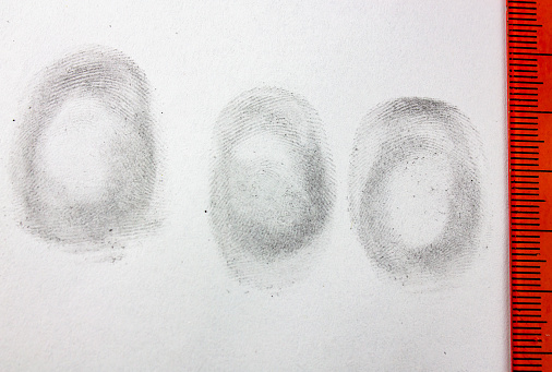 The Fingerprints on a white sheet. Fingerprinting. The concept of crime,fingerprints.Fingerprinting.