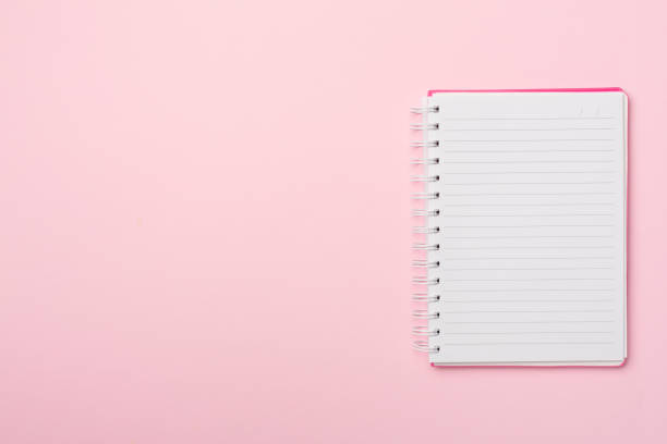 istock Pink notebook on color background, top view 1412031574