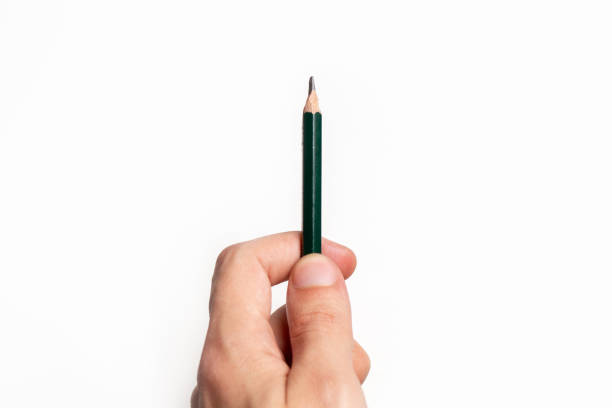 istock Person holding a pencil over blank paper 1412032583