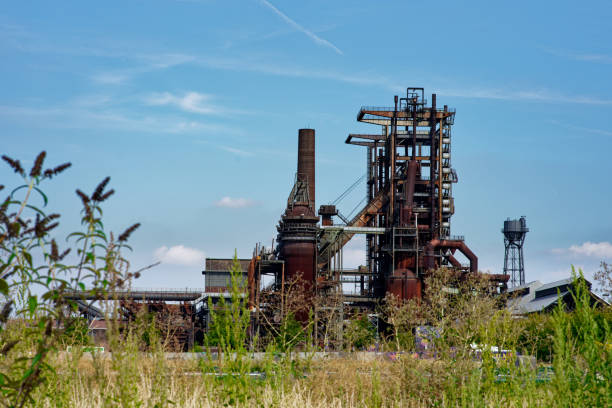 overview of steelworks building with sky and grass in front Dortmund, Germany - 07 30 2022 - steelworks - Hörder Bergwerks- und Hüttenverein Stahlwerk (Phoenix-Ost) rust germany stock pictures, royalty-free photos & images