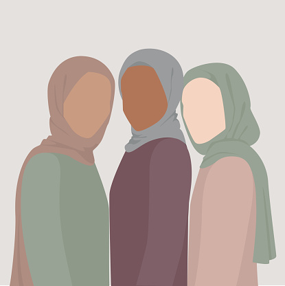 Three muslim women dressed in headscarves and long dresses