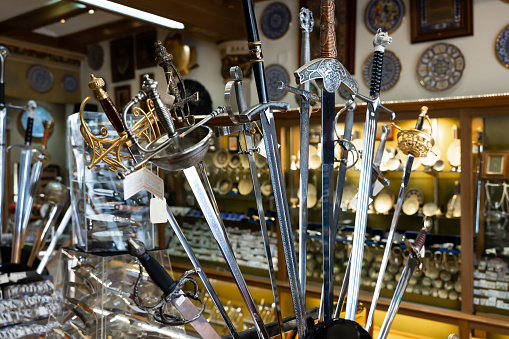 Collection of different old-fashioned swords in Toledo's souvenir shop.