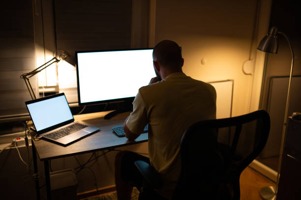 istock Male trader working late night at home. 1412036545