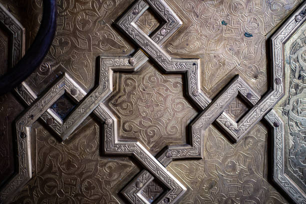 istock Iron door sculpture script detail on ancient Arabian gate close up still 1412045954