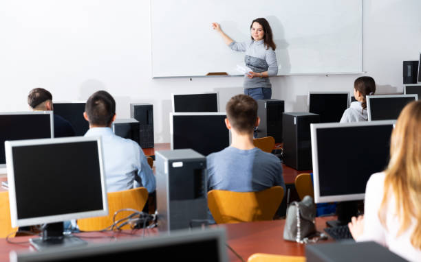 istock Woman lecturing students in computer room 1412048226