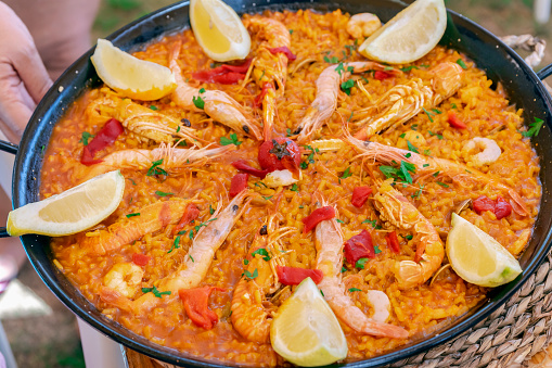 SEAFOOD PAELLA IN A TRADITIONAL PAN. TYPICAL SPANISH FOOD. SELECTIVE FOCUS. TOP VIEW.