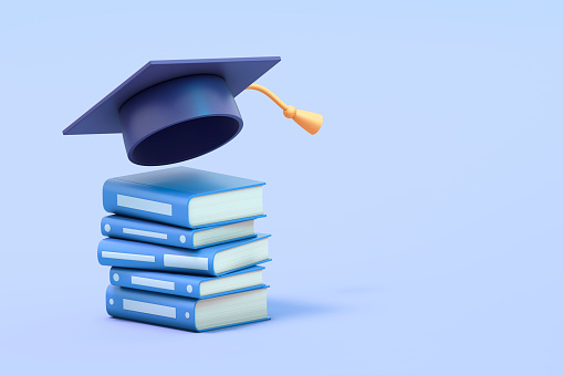Graduation hat and diploma on wooden background