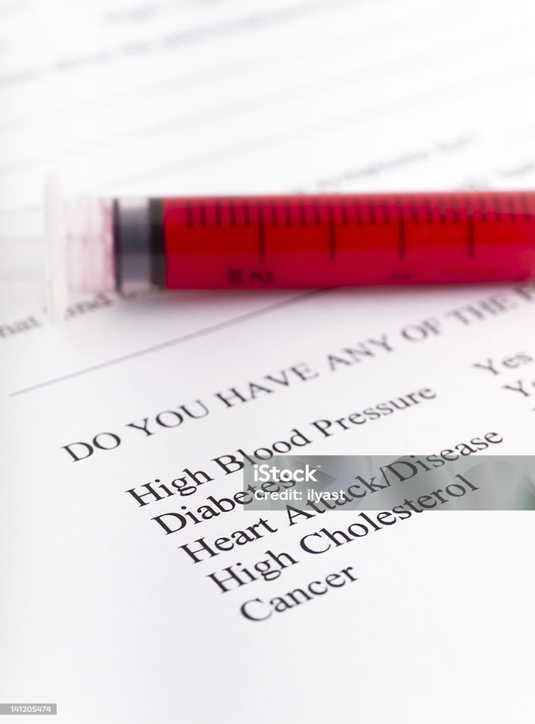 Syringe, blood and form Close up of a syringe with form at the background Blood Stock Photo