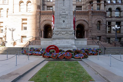 Toronto, Canada - November 16, 2021:  Wreathes at base of the Cenotaph at Old City Hall in Toronto after Remembrance Day’s ceremony.