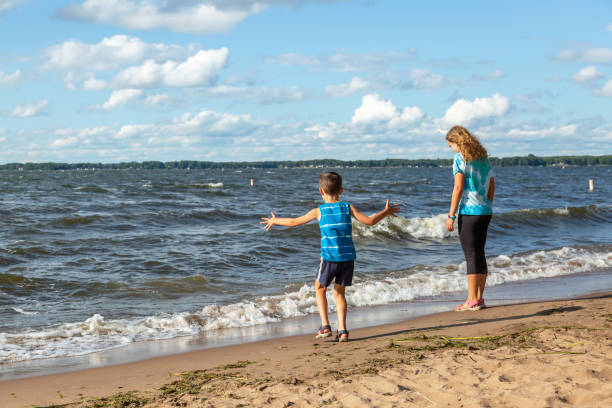 istock Sister & Brother Playing at Beach on Windy Day 1412055606