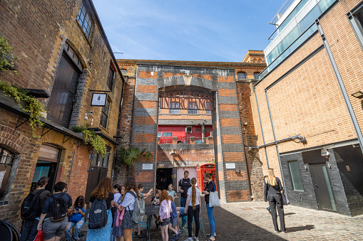 Interchange Building at Camden Market in Borough of Camden, London, with a group of people visible.