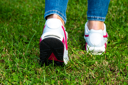 Close up woman walking on a path. Fitness concept.