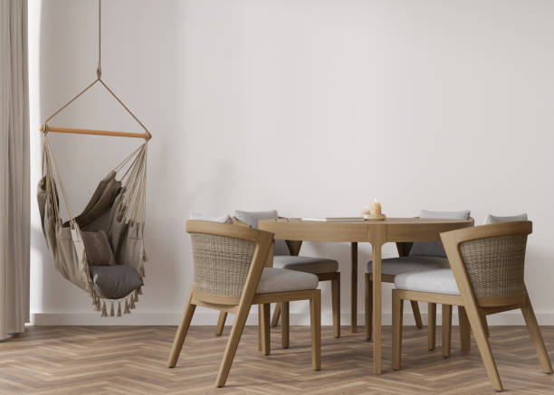istock Empty white wall in modern living room. Mock up interior in boho style. Free, copy space for your picture, text, or another design. Table with chairs, hanging armchair. 3D rendering. 1412055684
