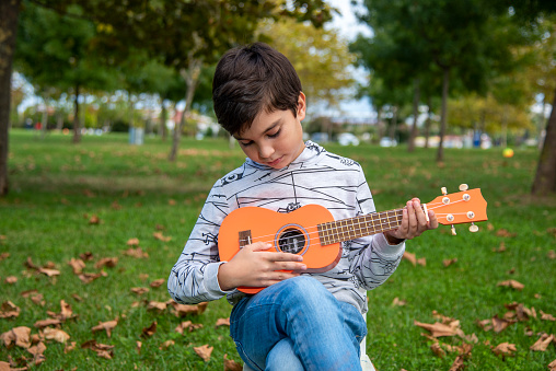 Little boy practicing guitar